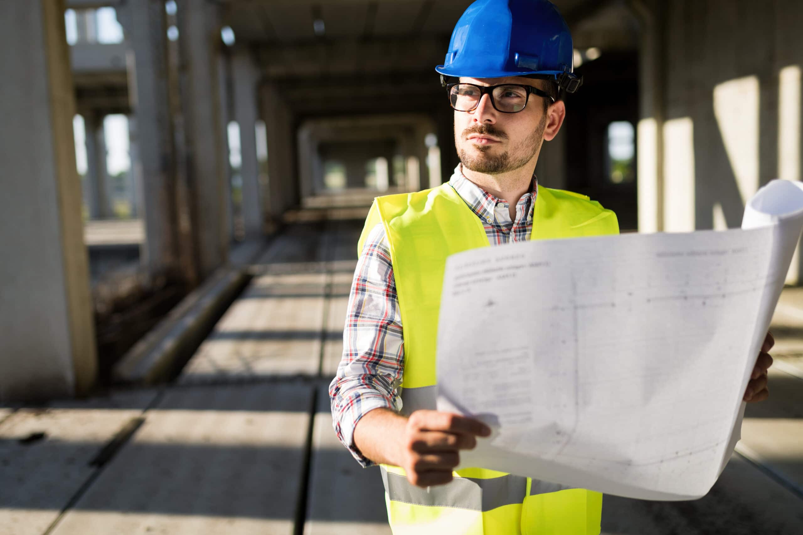 Engineer working on a building site, conducting a basement inspection.