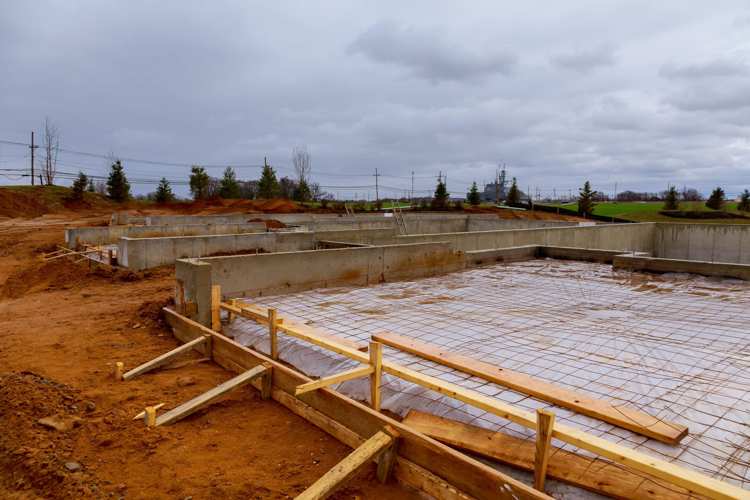 A construction site showing the foundation of new homes in progress.